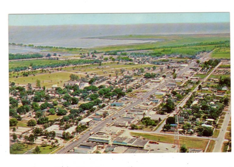 Chrome postcard. City of Clewiston looking east showing Clewiston Inn