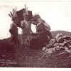 Old postcard.  Injuns made while you wait.  1907.  Woman making Indian headdresses for children.
