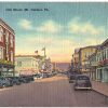 Linen postcard.  Oak Street, Mt Carmel, Pennsylvania.   J C Penney Sign, old cars.