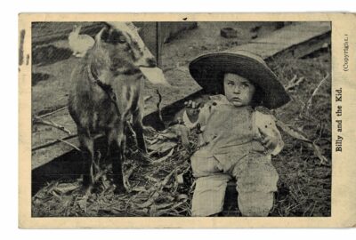 White border postcard.  Billy and the Kid.  Baby and goat. 1914. Big hat, rabbit.