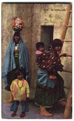 Postcard. In Hopiland.   Family climbing ladder, baby, women, child. Hopi Indians. 1943.
