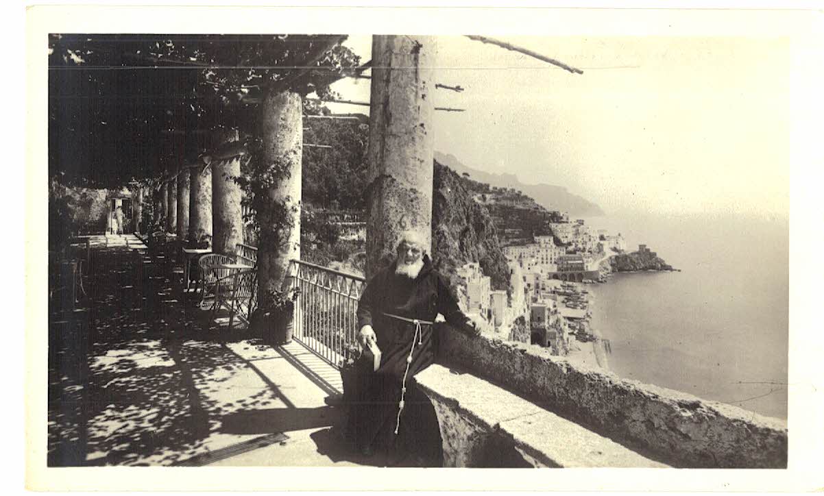 Real Photo Postcard. Monk sitting on wall, Hotel Cappuccini, Amalfi, Italy. RPPC.