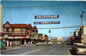 Chrome postcard.  Fourth Avenue, Anchorage, Alaska.  All American City.  First day of issue stamp, Amateur Radio, 5 cents.  1964.